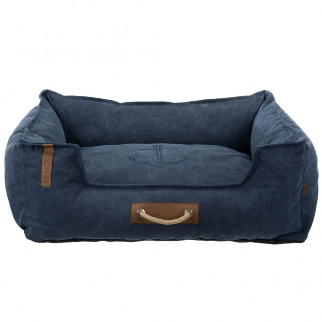 Dunkelblaues Hundebett in Wildleder-Optik, mit braunen Details, und einem aufgenähten Anker auf der Liegefläche